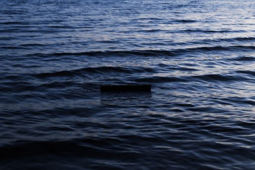 Serene ocean waves creating a calm ripple effect during twilight.