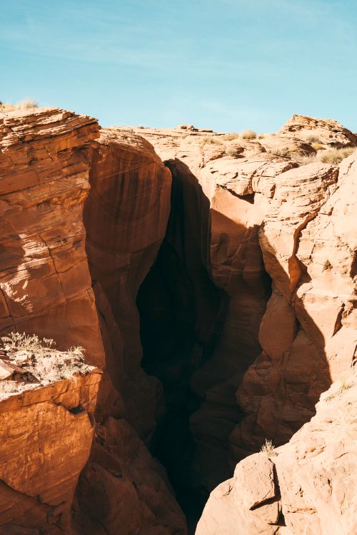 Free Explore the breathtaking beauty of Antelope Canyon's eroded sandstone formations under a clear blue sky. Stock Photo