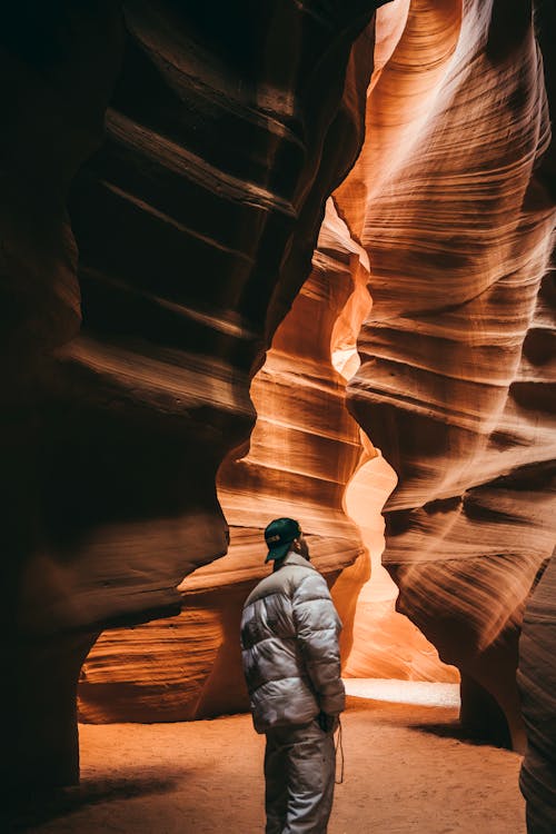 Man Looking at Rock Formation, Antelope Canyon, Arizona, USA