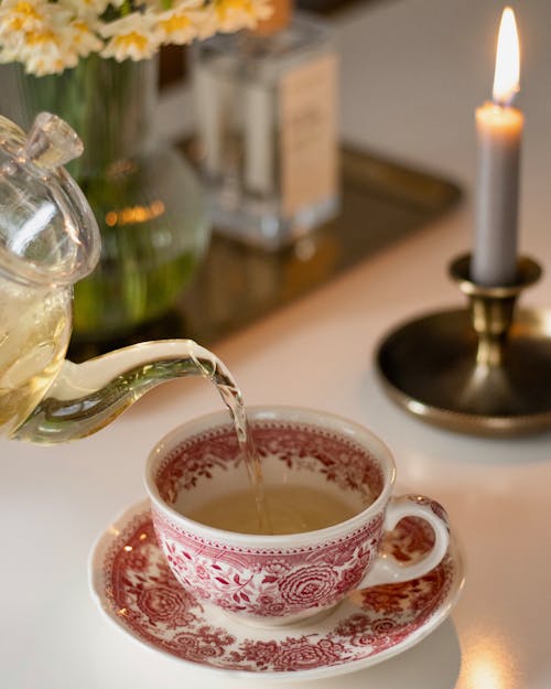 Pouring Tea to Porcelain Cup