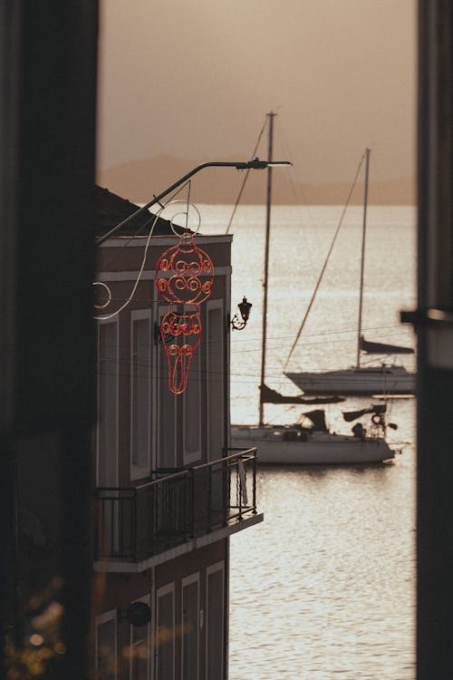 Moored Sailboats behind Building