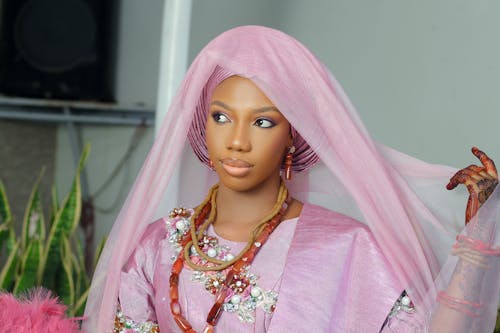 A woman in a pink dress and veil