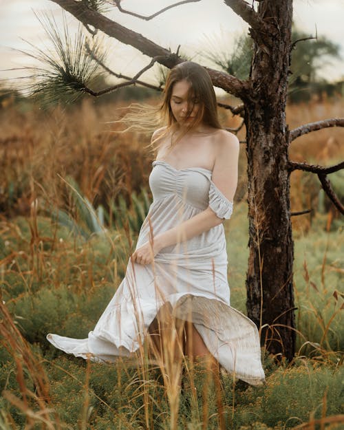 Young Woman in White Dress in the Field