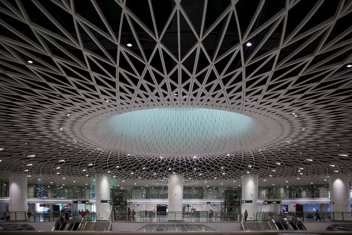 The striking geometric ceiling of a modern airport terminal