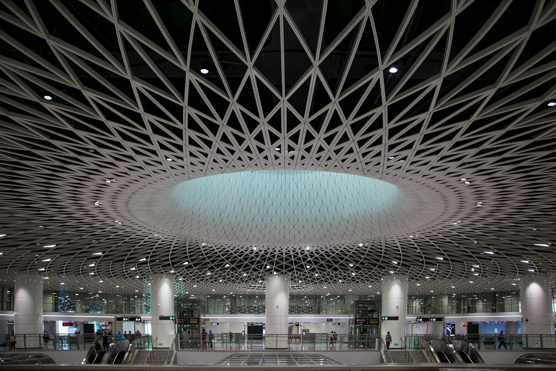 Sleek airport interior featuring a stunning geometric ceiling with dynamic lighting.