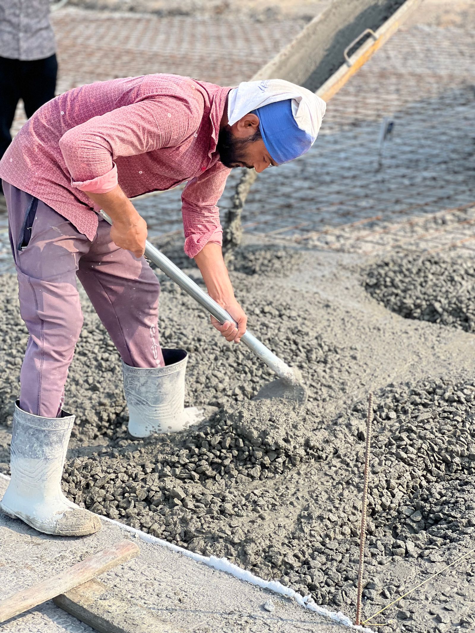 Crew member spreading fresh concrete for a new slab — Chat Widget for Contractors vs Phone: What Customers Use