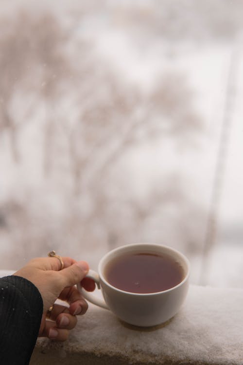 Woman Hand Holding Cup of Tea