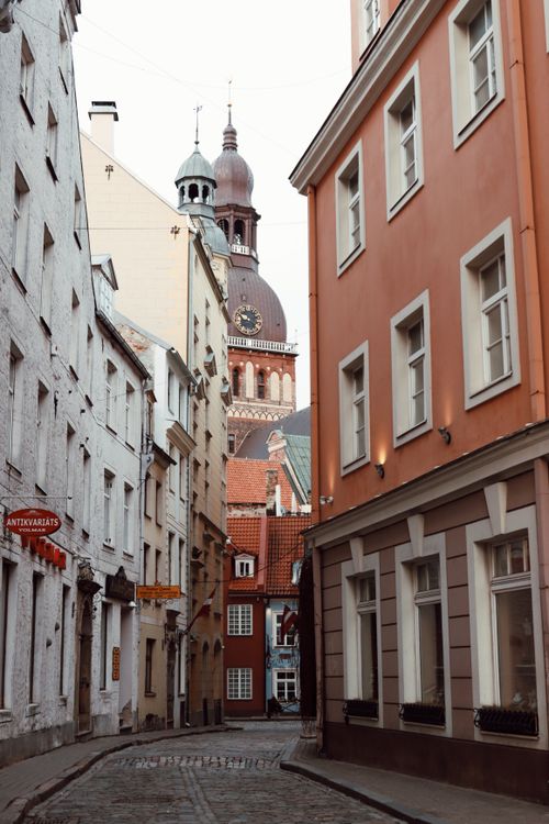 Free Explore the narrow, historic streets of Old Riga with stunning architectural details and church spire. Stock Photo
