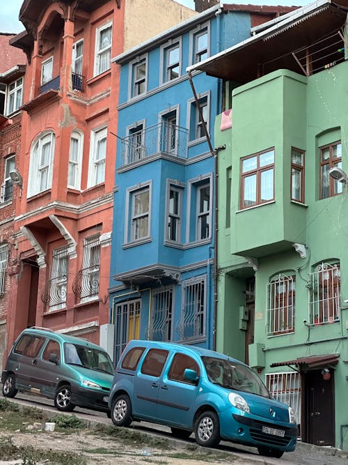 Cars Parked near Colorful Buildings Walls