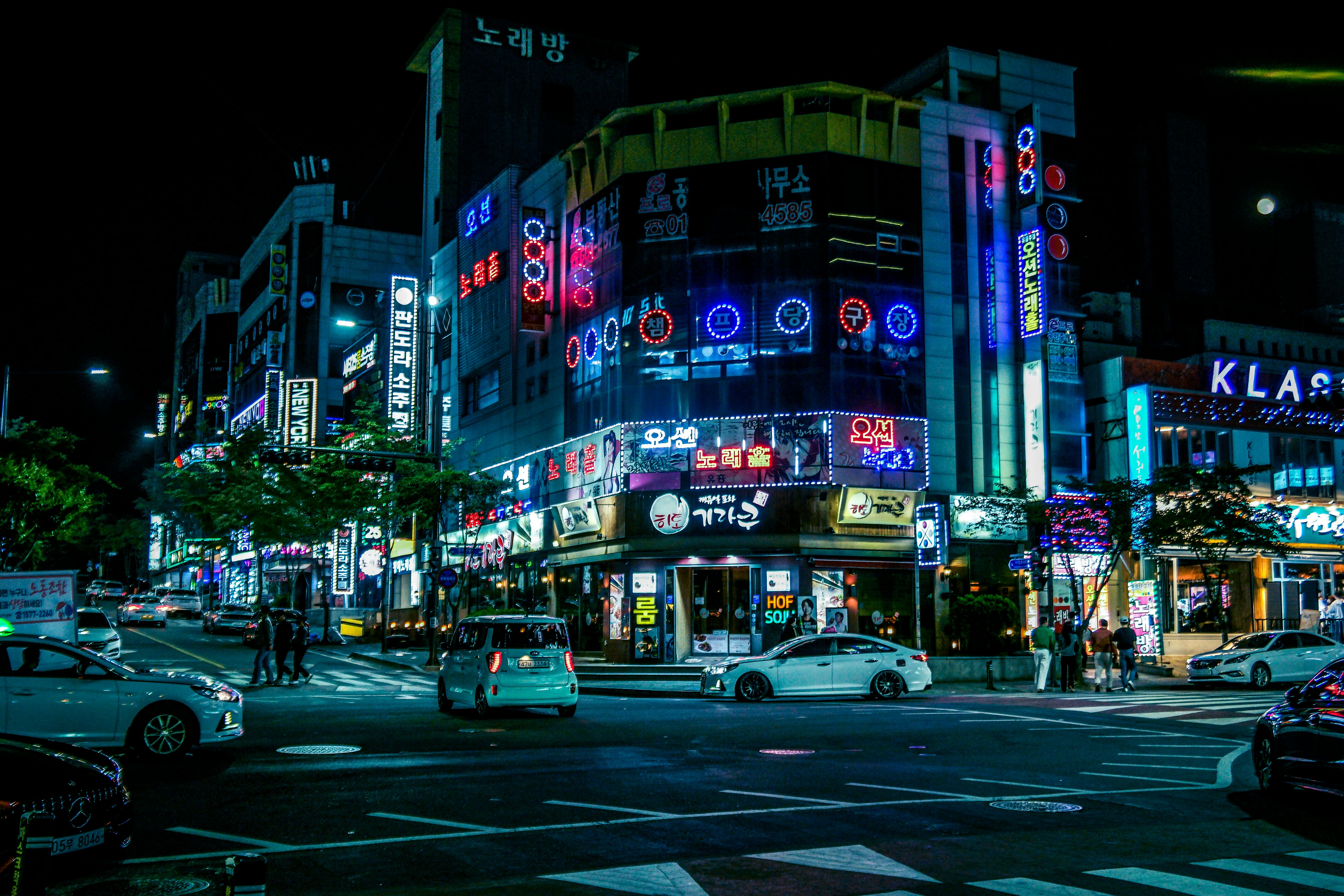 Illuminated street in Gwangju, South Korea, showcasing neon lights and city hustle at night.