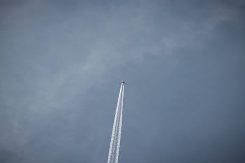 Contrails behind Flying Airplane