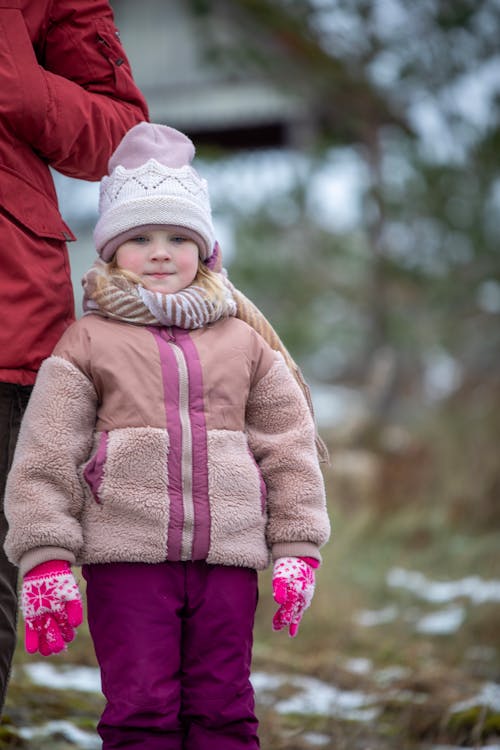 A Girl Standing Outdoors in Winter 