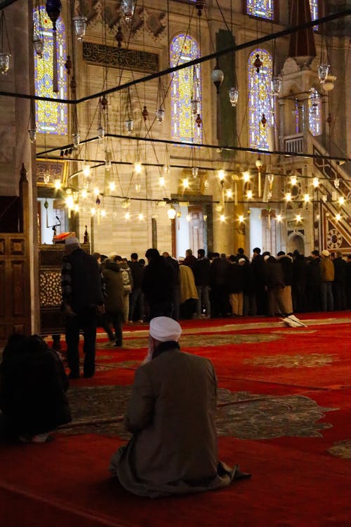 Free Men Praying at Ornamented Mosque Stock Photo