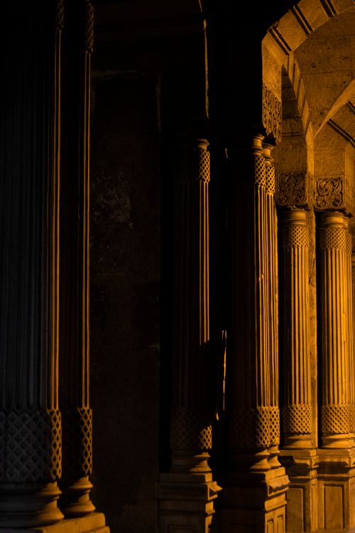 Free Dramatic lighting highlights elegant architectural columns during sunset, showcasing vintage design. Stock Photo