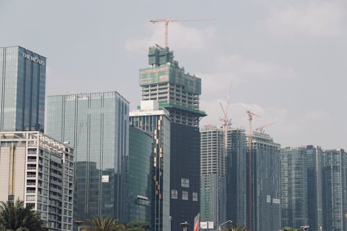 A large city with tall buildings and a large crane