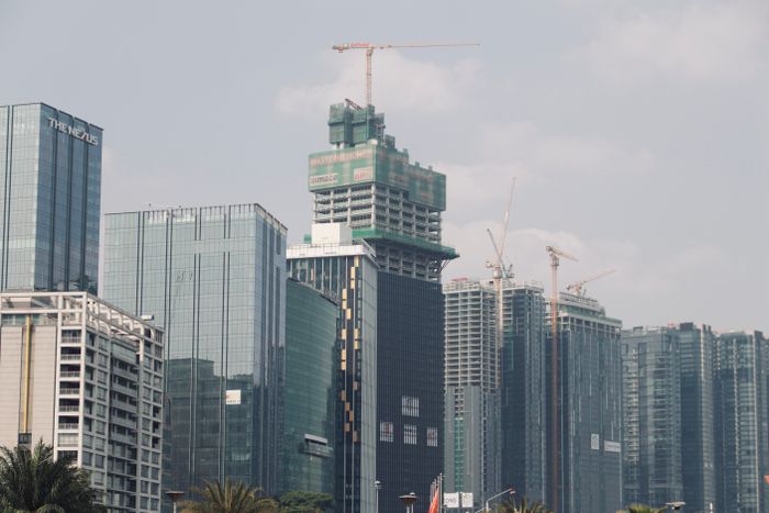 Tower cranes rising over a high-rise construction project