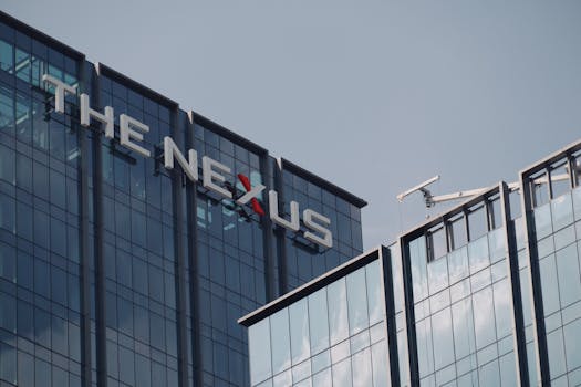 Low angle view of 'The Nexus' office building showcasing urban architectural design.