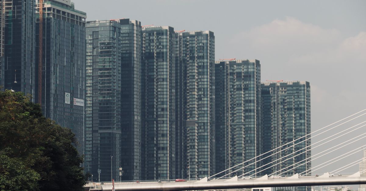 Skyscrapers and Thu Thiem 2 Bridge against Ho Chi Minh City's urban skyline.