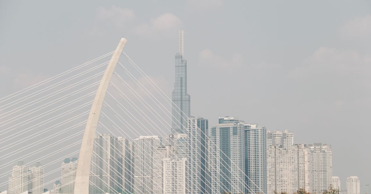 Skyline of Ho Chi Minh City featuring Thu Thiem 2 Bridge and modern skyscrapers on a clear day.