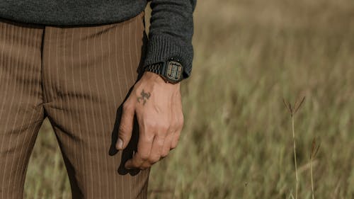 Tattto an Wristwatch on Man Hand