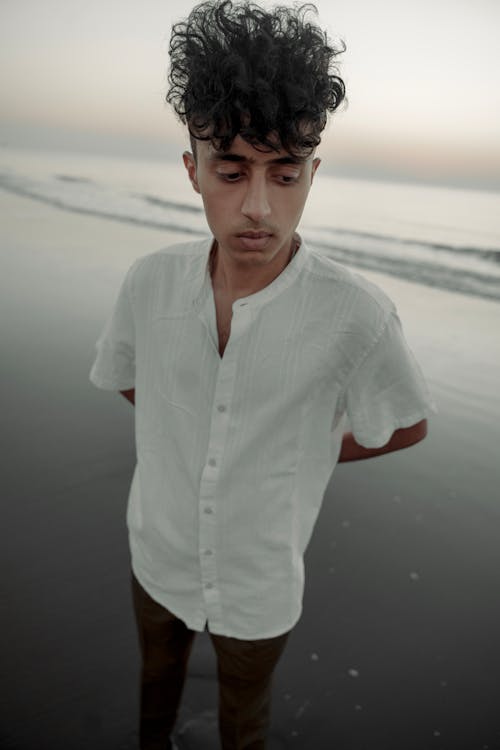 Portrait of Man in White Shirt on Beach