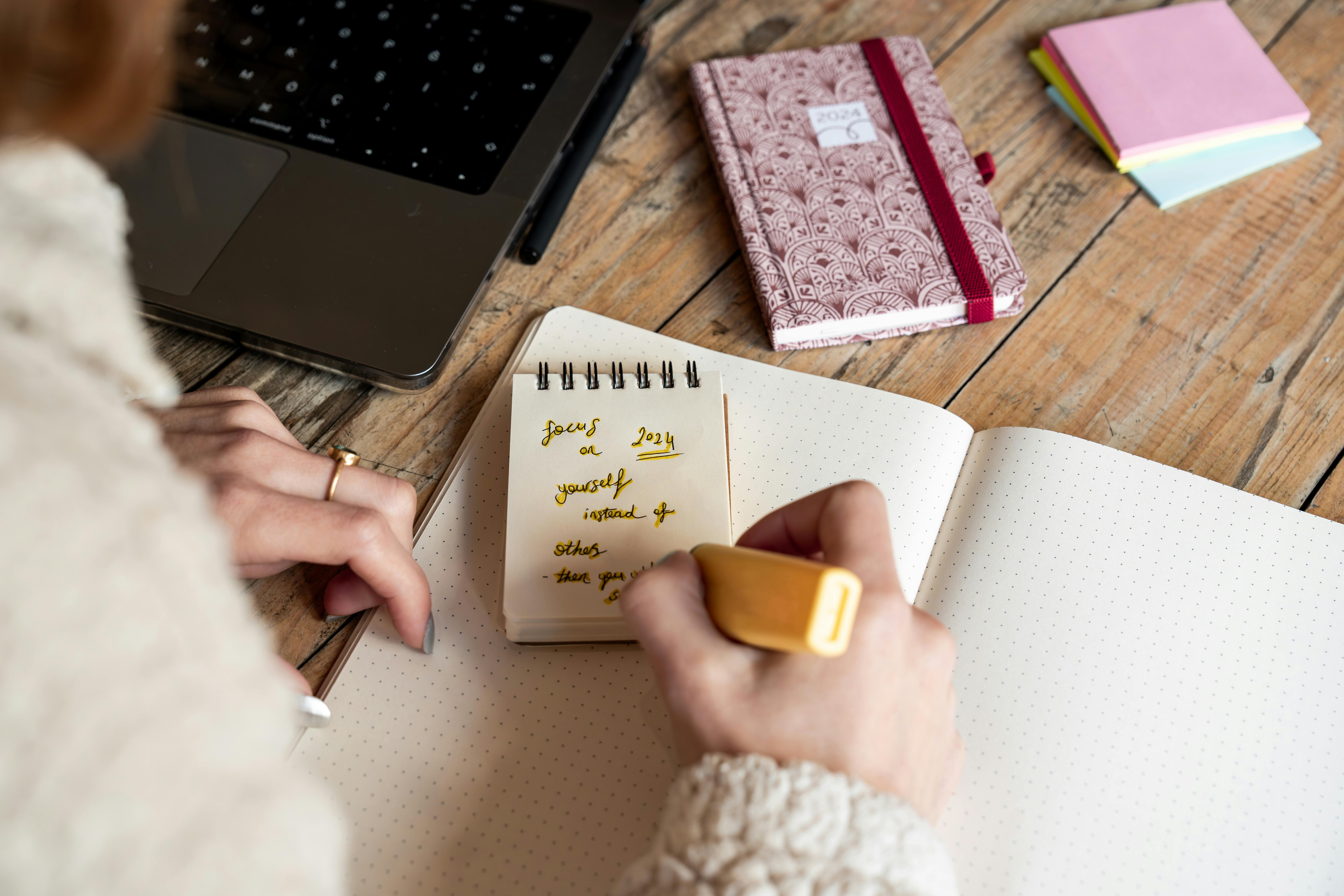 woman writing in notepad