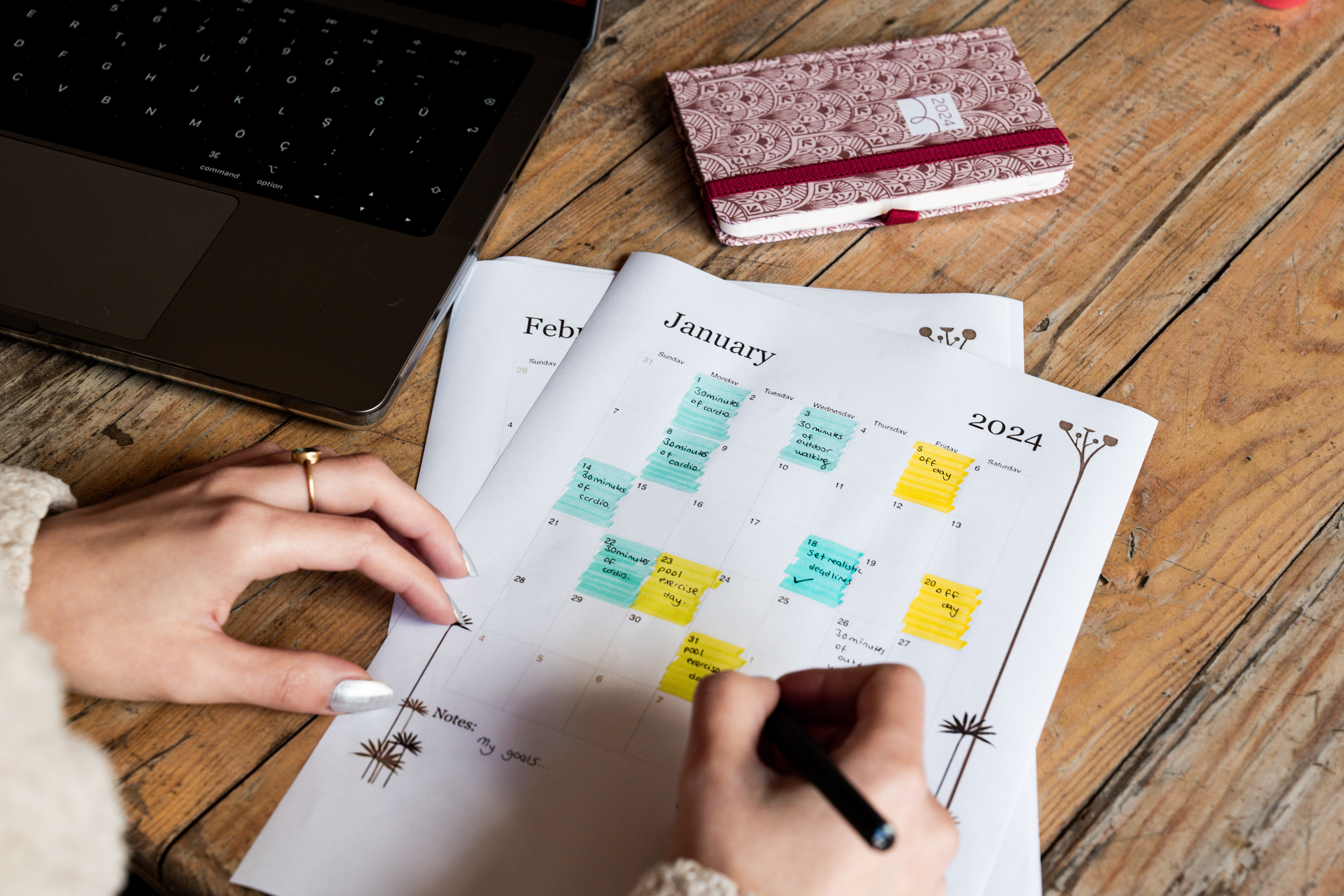 Busy household calendar packed with color-coded sticky notes and handwritten appointments — a reminder that dryer vent cleaning needs its own spot on the schedule, especially for families of four or more