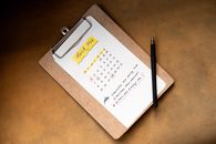Top view of a March 2024 calendar on a clipboard with a pen, ideal for planning or scheduling content.