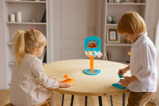 Two siblings enjoy a tabletop basketball game at home, fostering play and imagination.