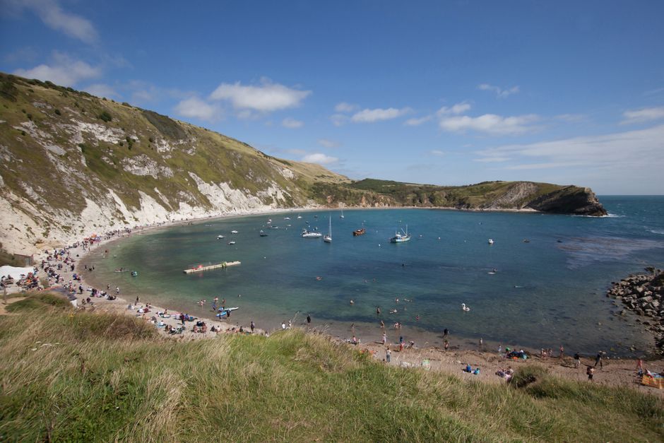 Explore the breathtaking Lulworth Cove in Dorset, England with rugged cliffs and crystal-clear waters.