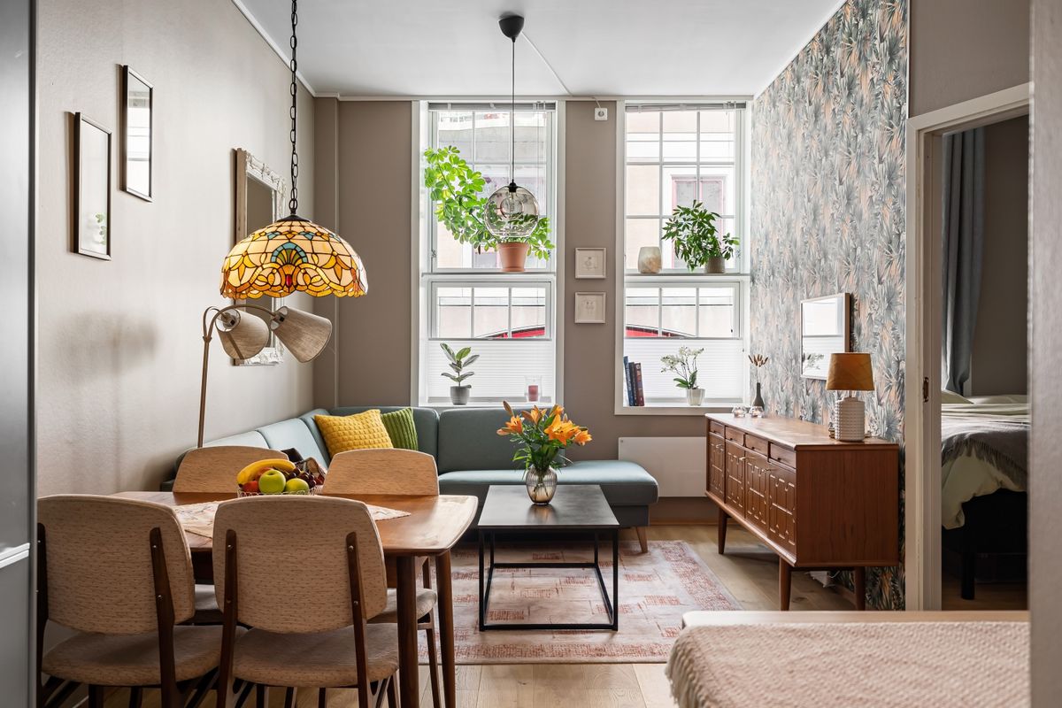Cozy living room with wooden furniture and greenery