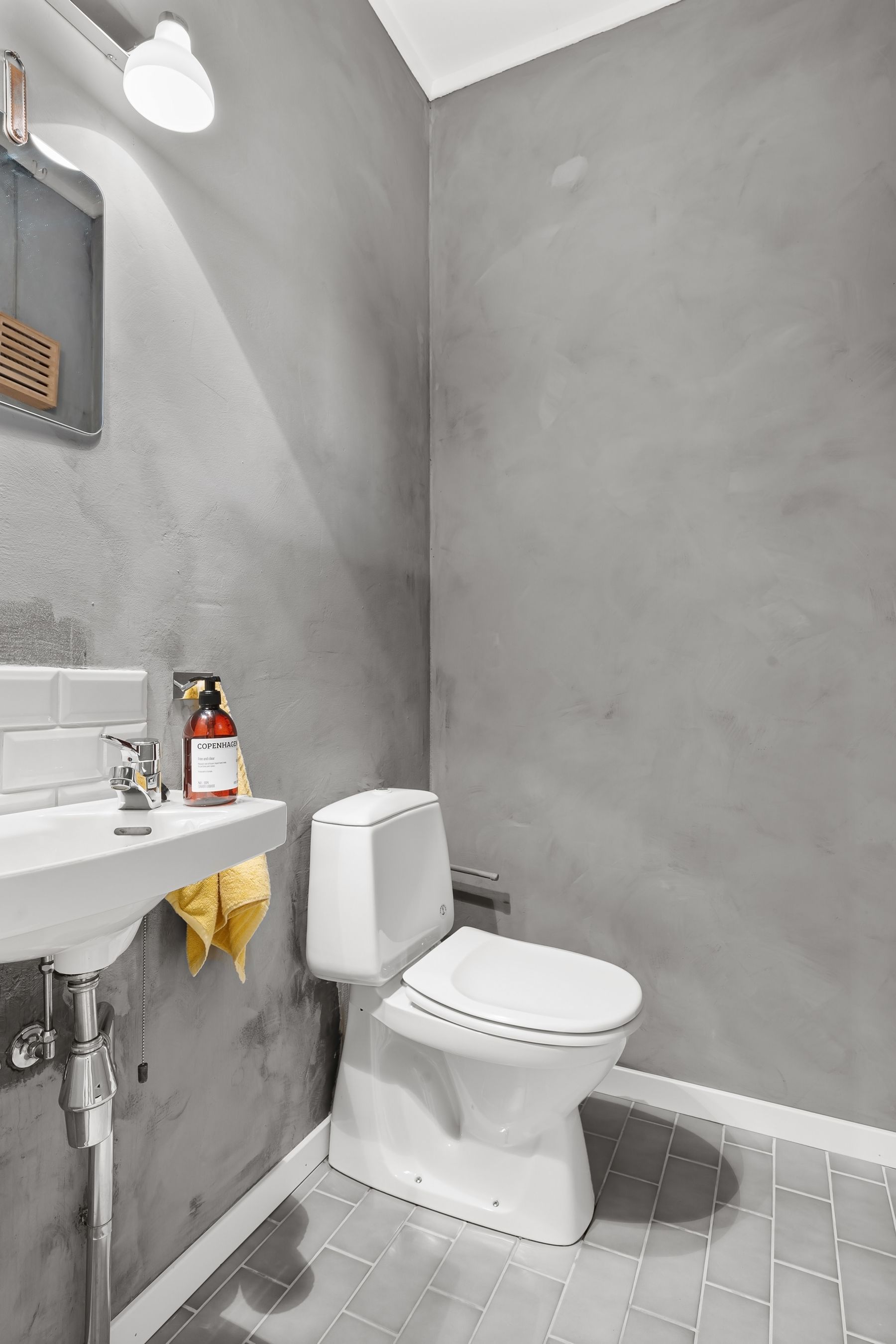 Contemporary grey bathroom with sink, mirror and restrained modern fixtures