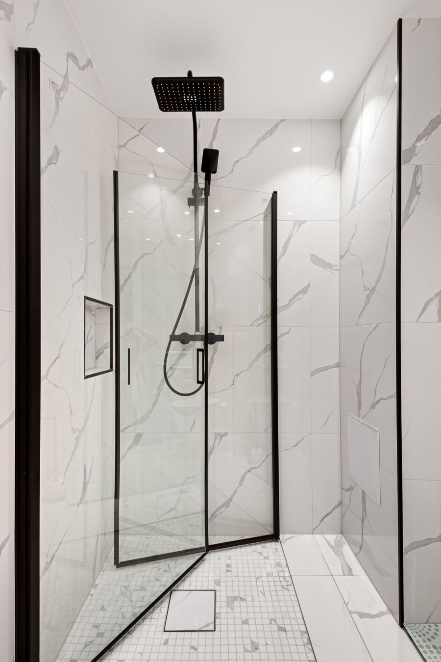 Clean residential shower tile and bathroom fixture update.