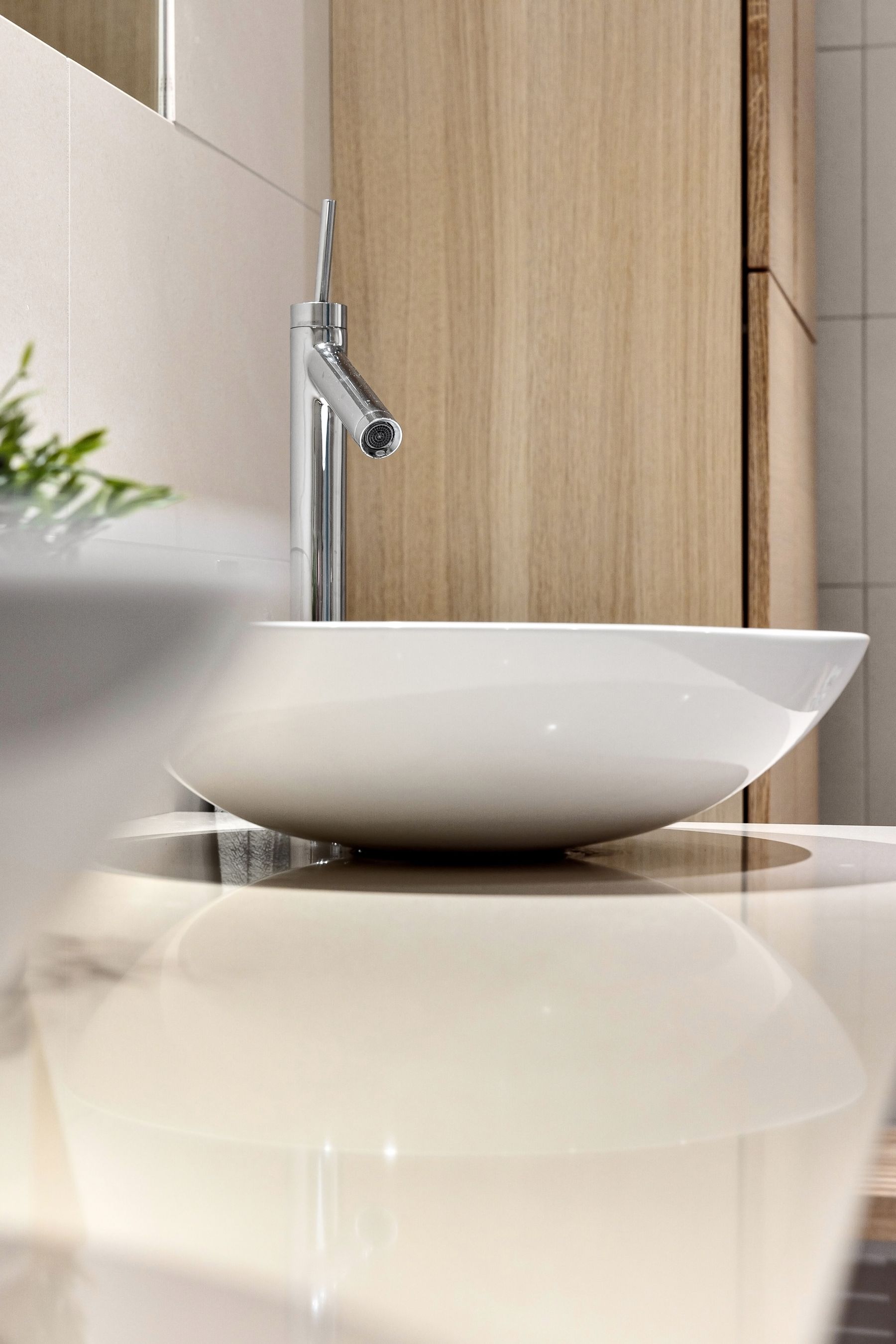 Minimalist bathroom sink with clean counter and restrained finishes