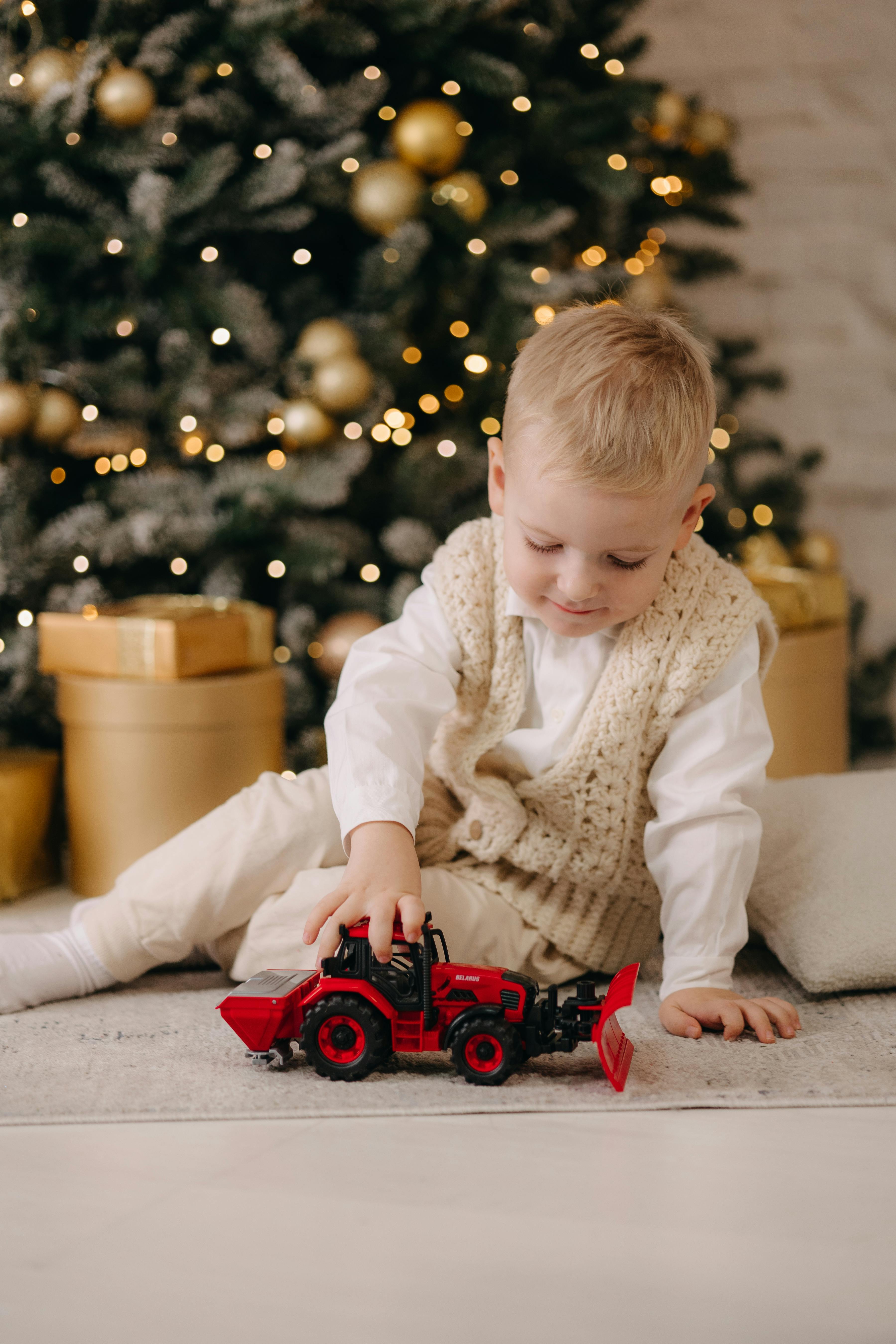 baby boy playing with tractor