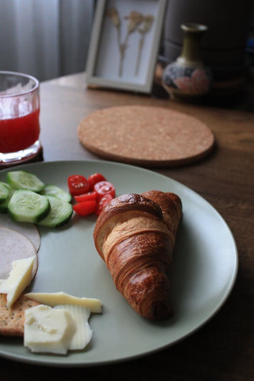 Croissant and Vegetables on Plate