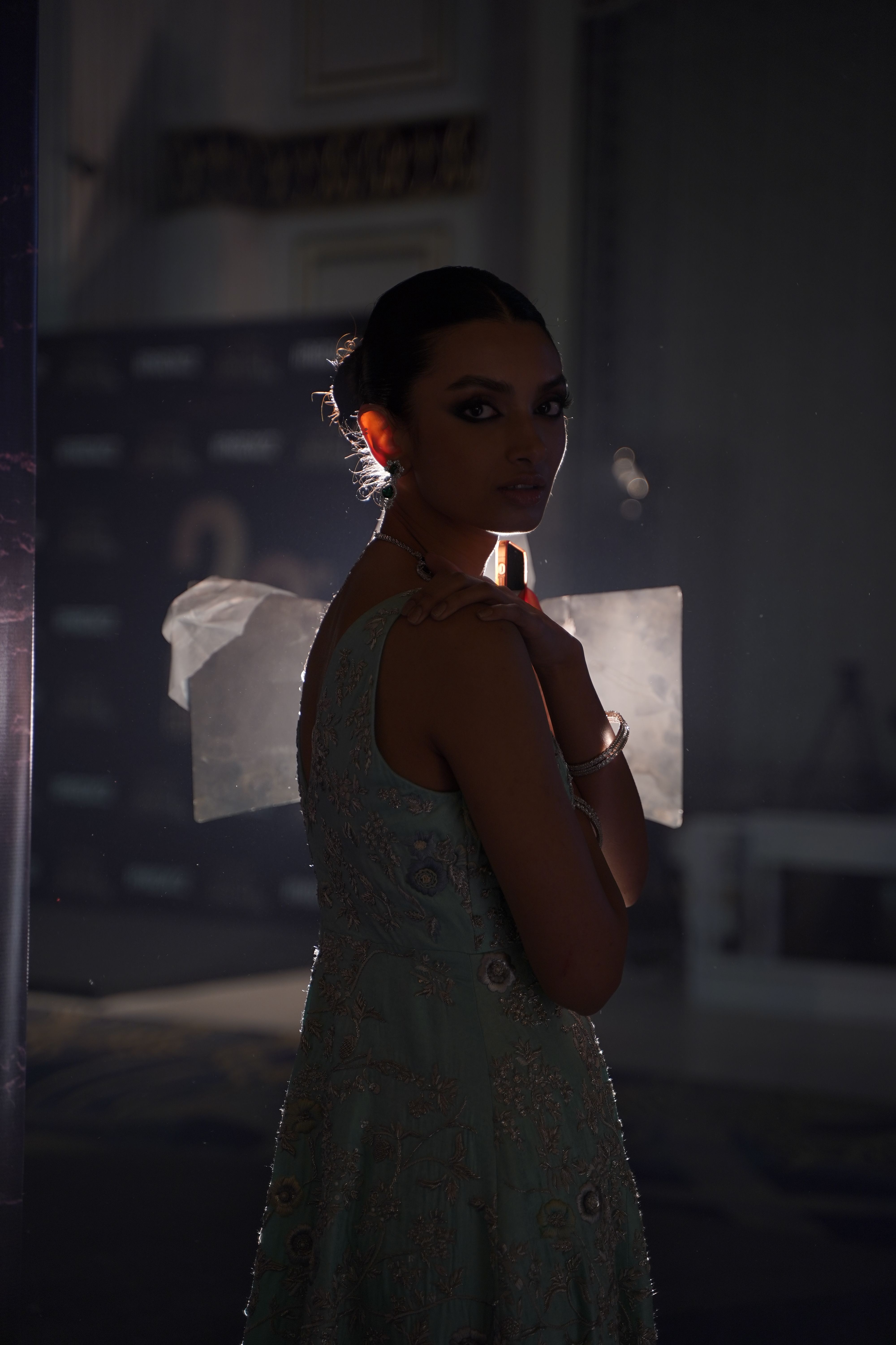 A woman in a dress standing in a dark room · Free Stock Photo