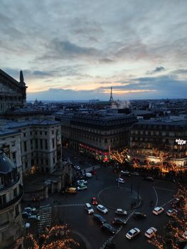 Captivating twilight aerial view of Paris city streets and the Eiffel Tower, showcasing the vibrant urban landscape.