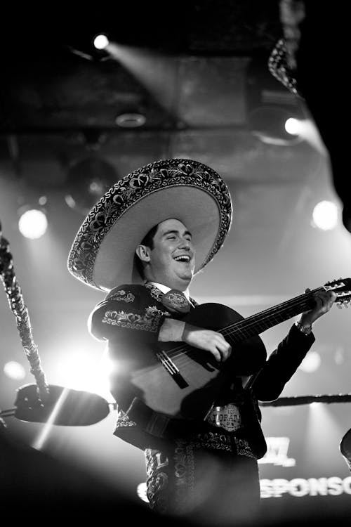 Man Wearing Sombrero Playing on Guitar in Black and White 
