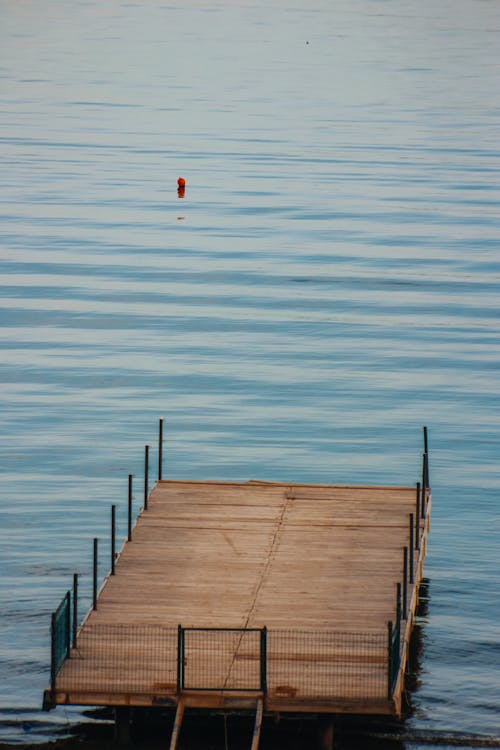 View of a Wooden Pier on a Body of Water 