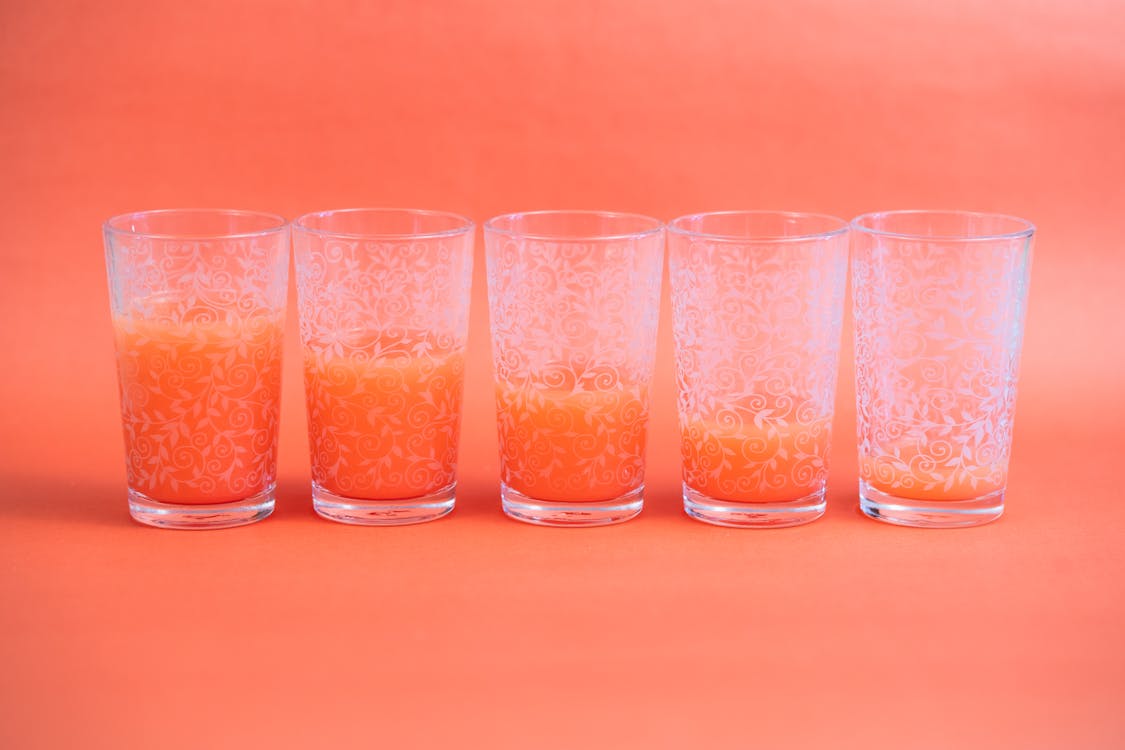 A Row of Glasses with Decreasing Level of Juice in Each Glass