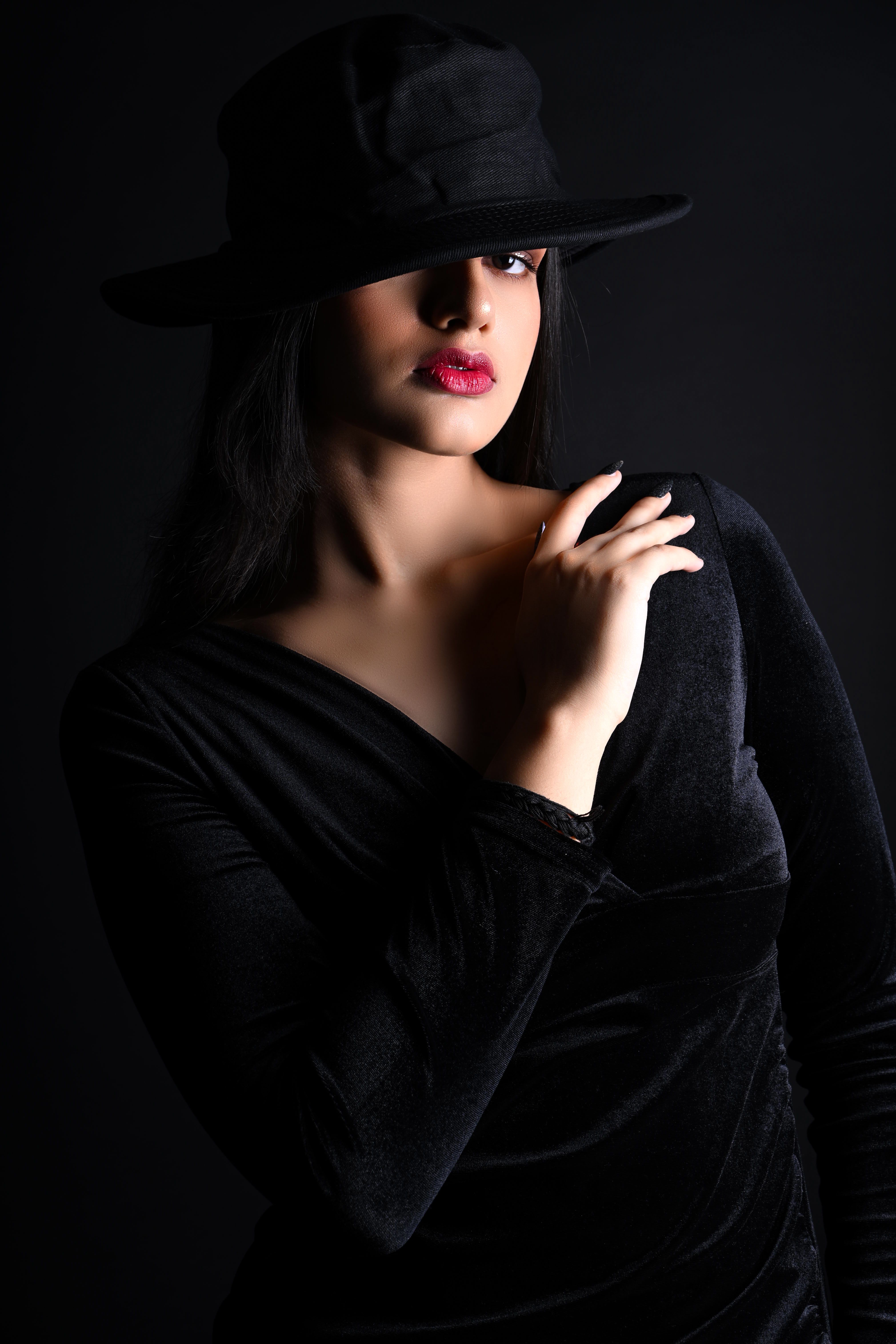 Black Studio Shoot of a Woman Wearing in a Hat · Free Stock Photo