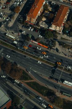 High-angle aerial view of a bustling urban street with heavy vehicle traffic.