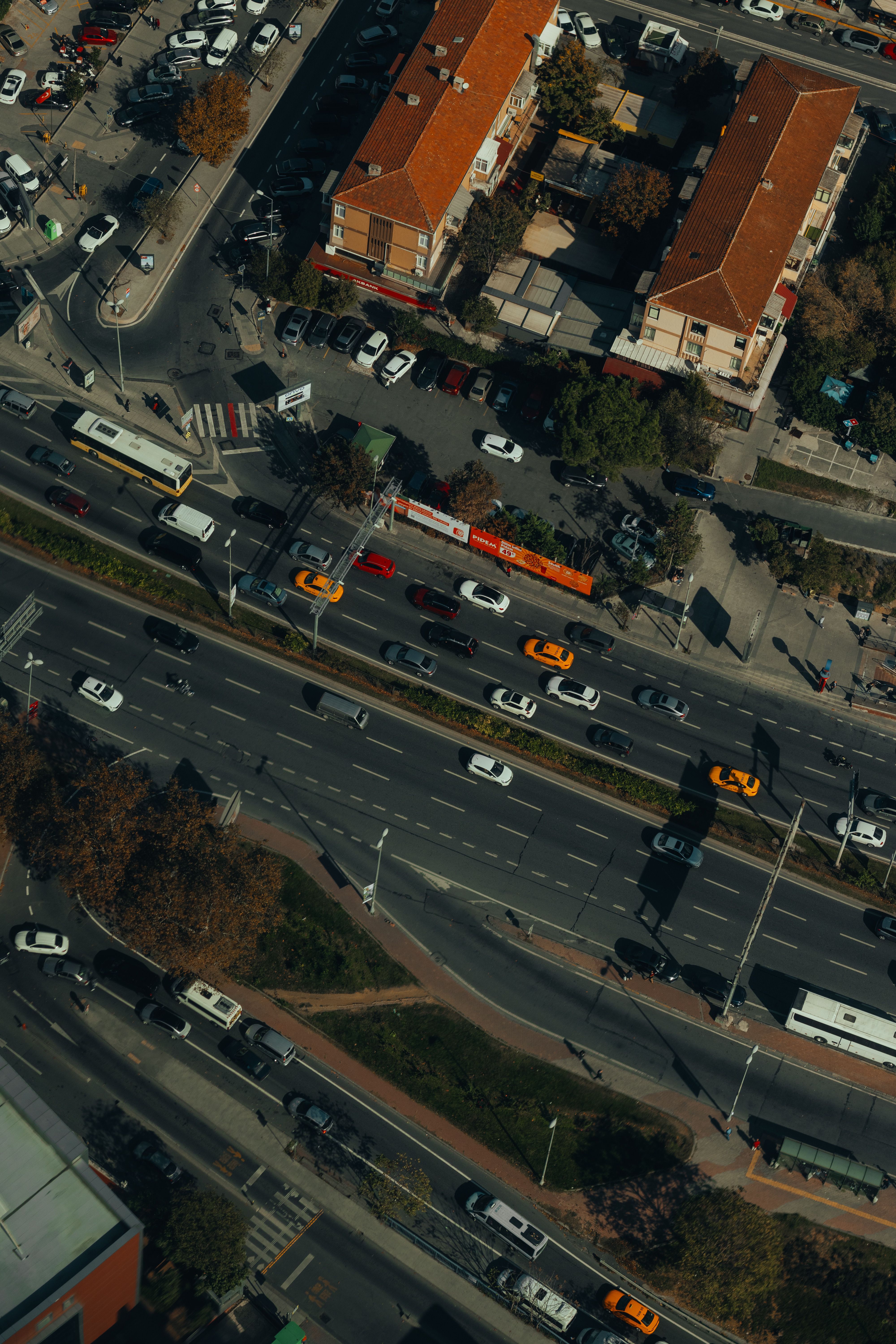An aerial view of a city street with cars and buses · Free Stock Photo