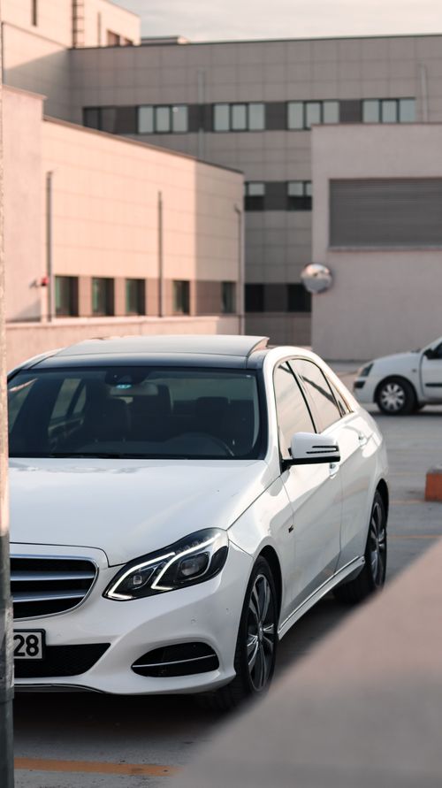 Free A sleek white Mercedes parked in an urban environment in Bursa, Türkiye. Stock Photo