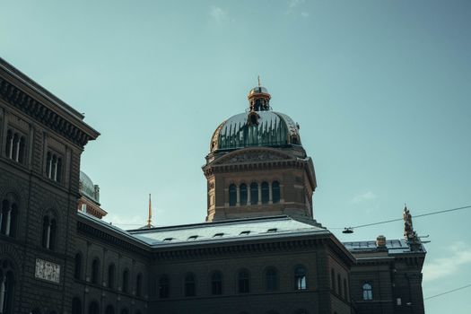 The Swiss Parliament Building in Bern showcased under a clear winter sky.