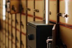 Close-up of vintage safety deposit boxes with one open, revealing secure interiors.
