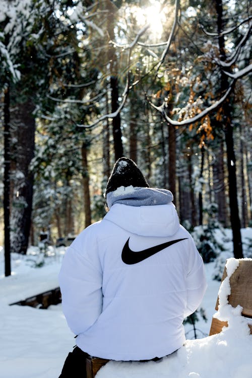 Man in White Jacket in Forest in Winter