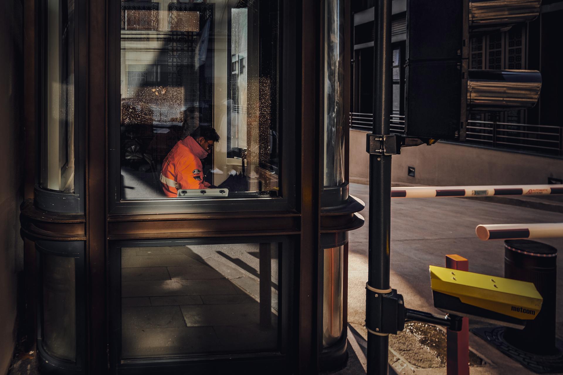 Security Guard Sitting in Booth