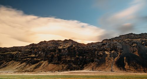 Free Breathtaking view of eroded rocky mountains with a vibrant sky at sunset, showcasing nature's beauty. Stock Photo
